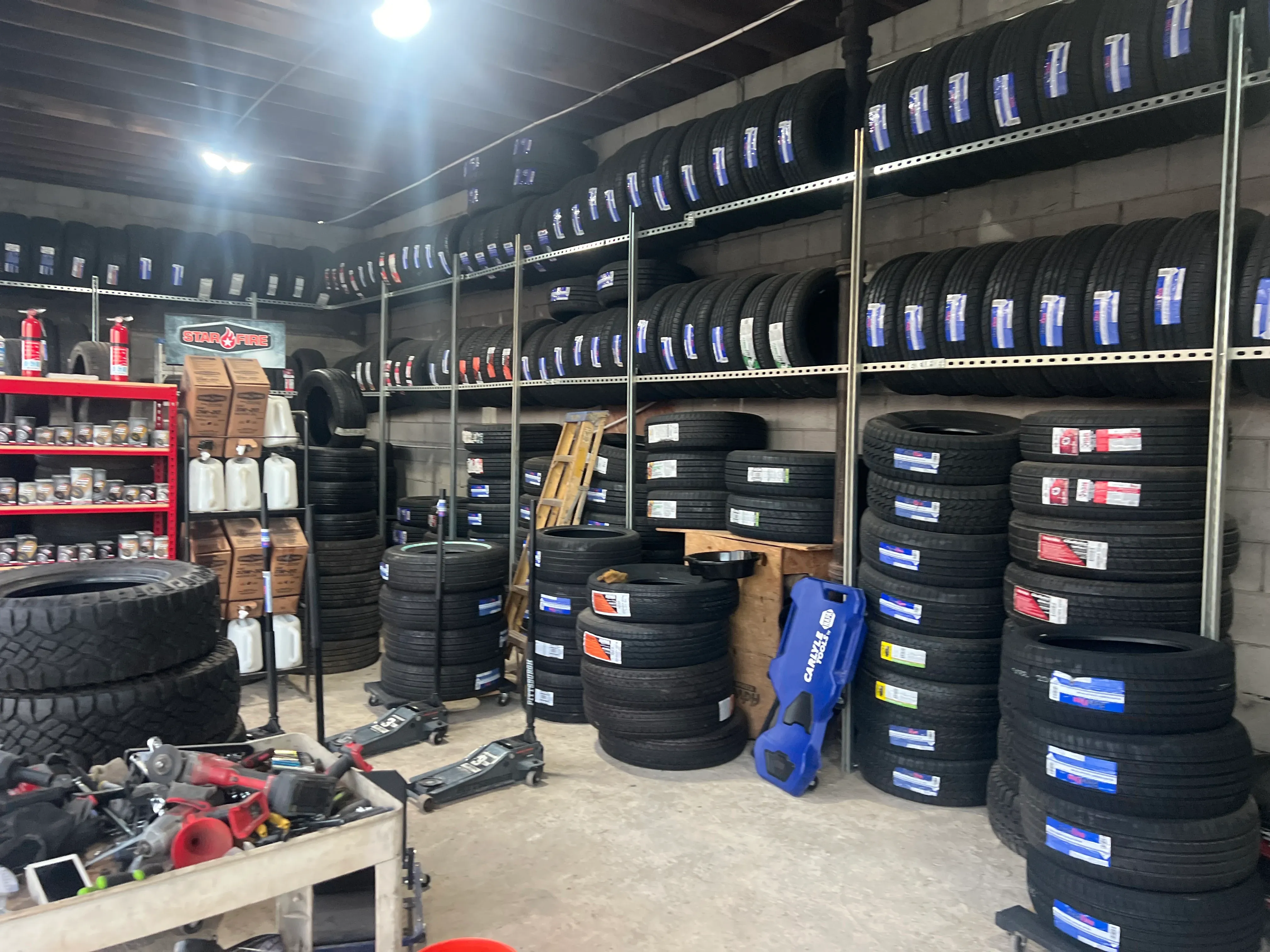 Nashville Flat Tire Service shop floor with new tires stacked along the wall — the team behind the Greater Nashville roadside tire service guides.